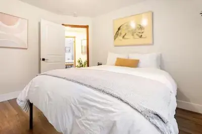 a bedroom with a large white bed with white sheets at Sleeps 10 Cozy Modern Cabin 4 bedroom 3 bath 2400 sq ft 3 story Updated Quiet cabin in Crestline