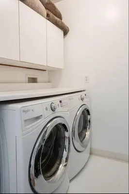 a white washing machine in a white kitchen at Amenity-Rich Abbot Kinney Venice Oasis! in Los Angeles