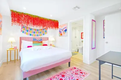 a bedroom with a white bed with a red headboard at H- Fab Family 5BD 4,5BA NoHo Escape Near Universal with Games, Deck, Parking in North Hollywood