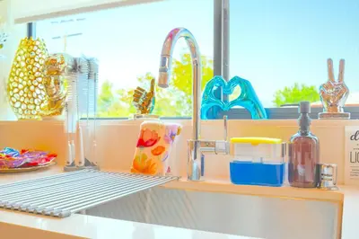 a kitchen counter with a sink and some dishes at H- Fab Family 5BD 4,5BA NoHo Escape Near Universal with Games, Deck, Parking in North Hollywood