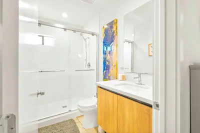a bathroom with a sink and a toilet and a shower at H- Fab Family 5BD 4,5BA NoHo Escape Near Universal with Games, Deck, Parking in North Hollywood