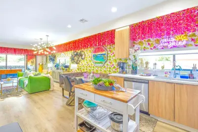 a kitchen and living room with a colorful wall at H- Fab Family 5BD 4,5BA NoHo Escape Near Universal with Games, Deck, Parking in North Hollywood