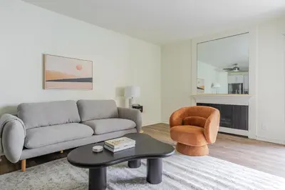 a living room with a couch and a chair at Blueground Pasadena pool nr Pasadena Park LAX-1391 in Los Angeles