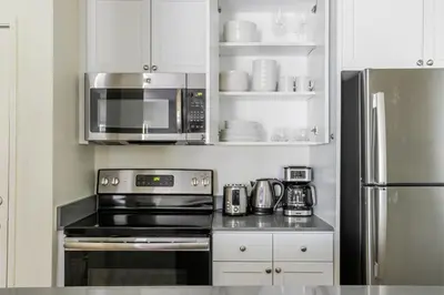 a kitchen with a stove and a microwave at Blueground Pasadena pool nr Pasadena Park LAX-1391 in Los Angeles