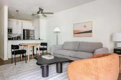 a living room with a couch and a table at Blueground Pasadena pool nr Pasadena Park LAX-1391 in Los Angeles
