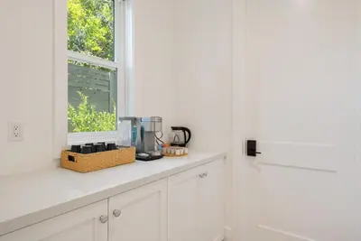 a kitchen with white cabinets and a window at 4mil WestLA Lux Manor Santa Monica and Beverly Hills in Los Angeles