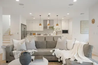 a living room with a couch and a kitchen at 4mil WestLA Lux Manor Santa Monica and Beverly Hills in Los Angeles