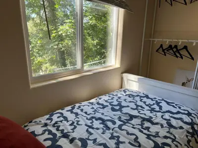 a bedroom with a bed and a window at Cozy Cabin in Crestline