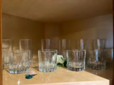 a row of empty glasses sitting on a table at Cozy Cabin in Crestline