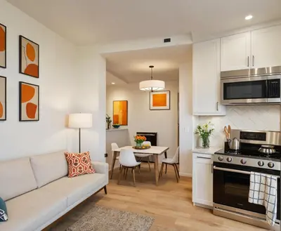 a kitchen and living room with a couch and a table at Venice Beach Getaway Steps from the Ocean Marina and Boardwalk in Los Angeles
