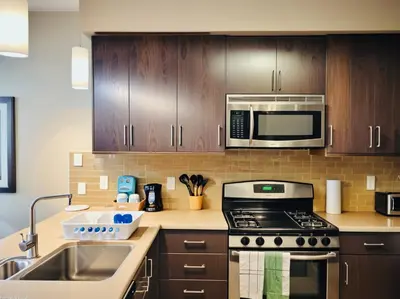 a kitchen with a stove and a microwave at Venice Beach Getaway Steps from the Ocean Marina and Boardwalk in Los Angeles