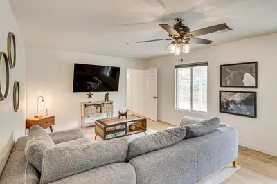 a living room with a couch and a ceiling fan at Patio, Fire Pit and Hillside Views Agua Dulce Home in Leona Valley