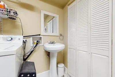 a bathroom with a sink and a white door at Lakeview Lookout in Skyforest