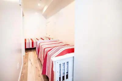 two beds in a white room with red and white blankets at Modern 2 Bedroom 3 Level Loft by Hollywood Close to Downtown LA Free Gated Parking Full Kitchen in Los Angeles
