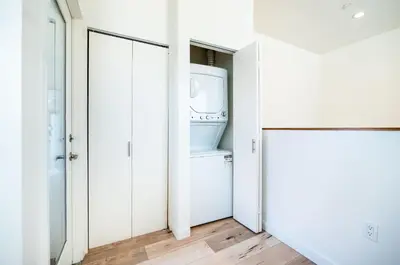 a laundry room with a washer and dryer at Modern 2 Bedroom 3 Level Loft by Hollywood Close to Downtown LA Free Gated Parking Full Kitchen in Los Angeles