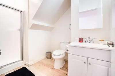 a white bathroom with a toilet and a sink at Modern 2 Bedroom 3 Level Loft by Hollywood Close to Downtown LA Free Gated Parking Full Kitchen in Los Angeles
