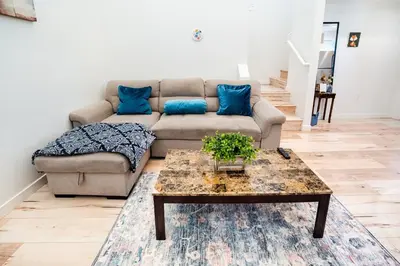 a living room with a couch and a coffee table at Modern 2 Bedroom 3 Level Loft by Hollywood Close to Downtown LA Free Gated Parking Full Kitchen in Los Angeles