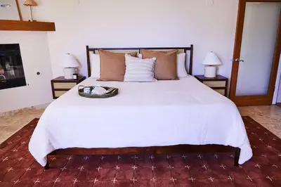 a bedroom with a large white bed with two lamps at Oja Mountain Ridge in Ojai