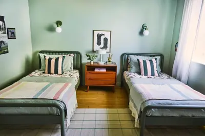 two beds sitting in a room with a table at Oja Mountain Ridge in Ojai