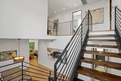 a staircase in a house with a living room at Vast Mar Vista Residence in Los Angeles