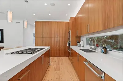 a kitchen with wooden cabinets and a white counter top at Vast Mar Vista Residence in Los Angeles