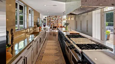 a kitchen with white cabinets and a stove top oven at Howard Hughes Estate in Los Angeles