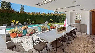 a patio with a table and chairs and a pool at Howard Hughes Estate in Los Angeles