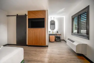 a bedroom with a bed and a television and a desk at LYFE INN & SUITES by AGA- North Hollywood Near Universal Studios in North Hollywood