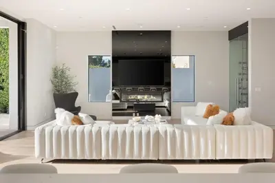 a living room with a white couch and a tv at The Artezen Villa by Stay Awhile Villas in Los Angeles