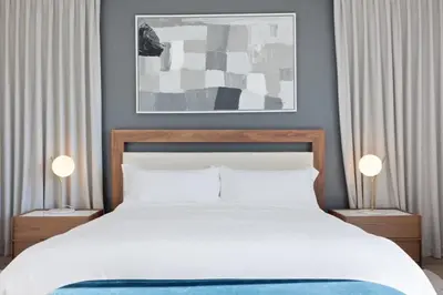 a bedroom with a large white bed with two lamps at The Artezen Villa by Stay Awhile Villas in Los Angeles