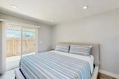 a bedroom with a bed and a large window at Seaspray at Anacapa View in Port Hueneme