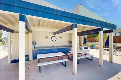 a pavilion with benches and tables on a patio at Seaspray at Anacapa View in Port Hueneme
