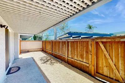 a wooden fence on a porch with a wooden gate at Seaspray at Anacapa View in Port Hueneme