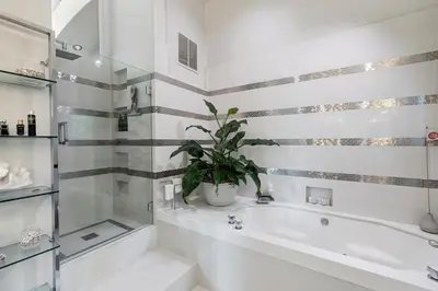 a bathroom with a tub and a potted plant at Hollywood Hills Luxury Retreat in Los Angeles