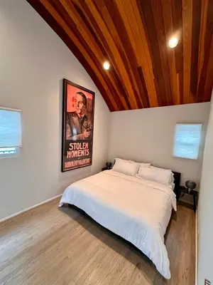 a bedroom with a bed with a poster on the wall at Hollywood Hills Luxury Retreat in Los Angeles