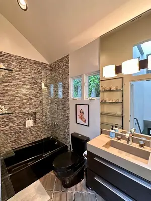 a bathroom with a black toilet and a sink at Hollywood Hills Luxury Retreat in Los Angeles