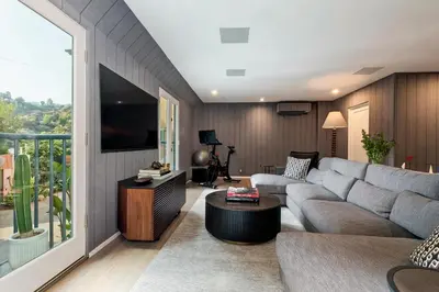 a living room with a couch and a tv at Hollywood Hills Luxury Retreat in Los Angeles