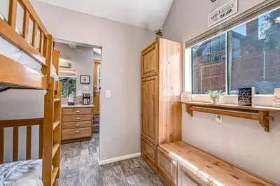 a bedroom with a bunk bed and a window at Castle Rock Cabin #1 ~ Comfortable cabin with modern amenities and deck - near hiking and lake in Big Bear Lake