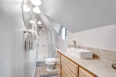a white bathroom with a sink and a toilet at Castle Rock Cabin #1 ~ Comfortable cabin with modern amenities and deck - near hiking and lake in Big Bear Lake