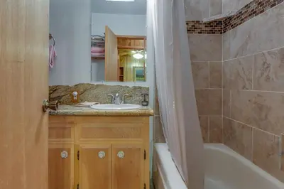 a bathroom with a sink and a tub and a toilet at Castle Rock Cabin #2 ~ Cozy cabin close to Fisher Cove & Boulder Bay - short drive to skiing in Big Bear Lake