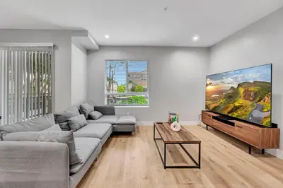 a living room with a couch and a flat screen tv at 546 Havard in Los Angeles