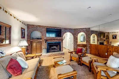 a living room with a couch and a fireplace at Rosie's Hideaway ~ Spacious Retreat Near the Mountain & Lake with Grill & Full Kitchen in Big Bear Lake