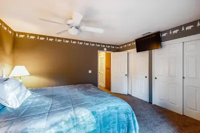 a bedroom with a bed and a ceiling fan at Rosie's Hideaway ~ Spacious Retreat Near the Mountain & Lake with Grill & Full Kitchen in Big Bear Lake