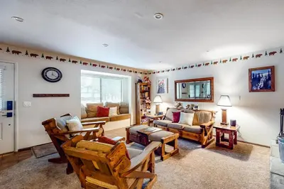 a living room with wooden chairs and a couch at Rosie's Hideaway ~ Spacious Retreat Near the Mountain & Lake with Grill & Full Kitchen in Big Bear Lake