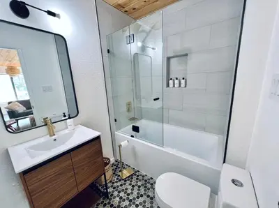 a bathroom with a toilet and a sink and a shower at Brentwood Haus in Lake Arrowhead