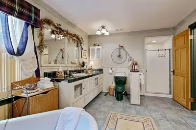 a large bathroom with a tub and a sink at Rooster's Den ~ Charming house with expansive deck, cable, internet, near Big Bear Lake in Big Bear Lake
