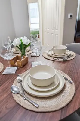 a dining room table with plates and silverware on it at Modern 1bd apt in Marina del Rey w Free Parking in Los Angeles