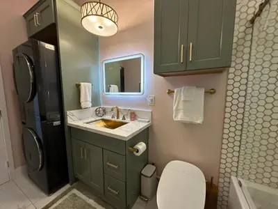 a bathroom with a sink and a black refrigerator at Stylish Highland Park Home in Los Angeles