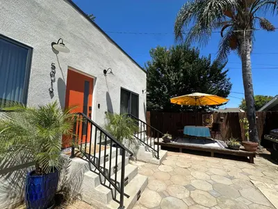 a house with an orange door and an umbrella at Stylish Highland Park Home in Los Angeles