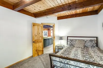 a bedroom with a bed and a wooden ceiling at Summit Hideaway ~ Fantastic Mountain getaway with private hot tub, free Wi-Fi, full kitchen, & more in Big Bear Lake